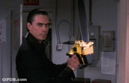A Man Holding A Chainsaw In Front Of A Sign That Says Exit GIF