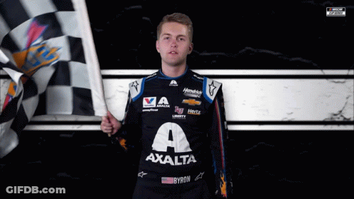 A Man Holding A Checkered Flag Wearing A Shirt That Says Axalta On It GIF