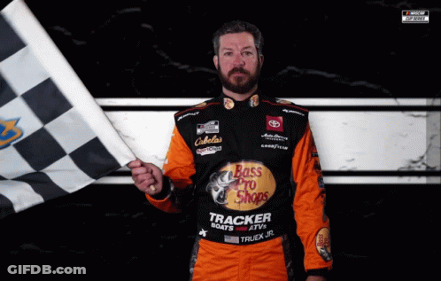 A Man Holding A Checkered Flag Wears A Bass Pro Shops Uniform GIF