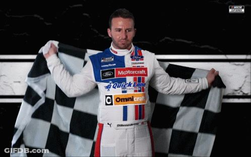 A Man Holding A Checkered Flag With The Word Motorcraft On His Shirt GIF