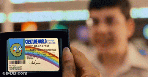 A Man Holding A Creature World Driver 'S License GIF