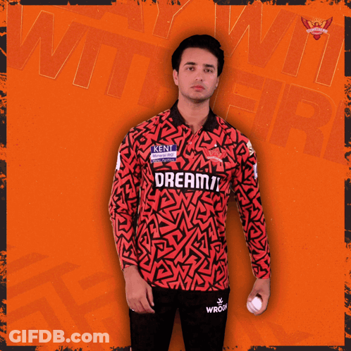 A Man Holding A Cricket Ball In A Jersey That Says Kent GIF