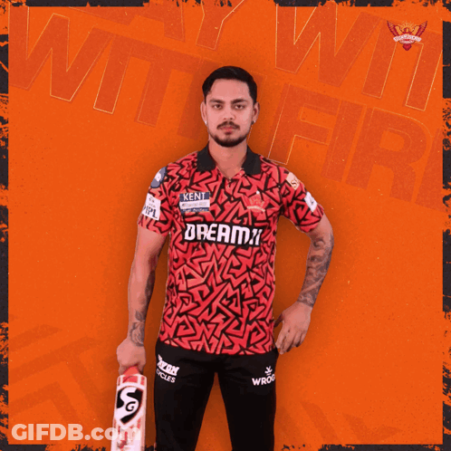 A Man Holding A Cricket Bat With The Word Dreamz On His Shirt GIF