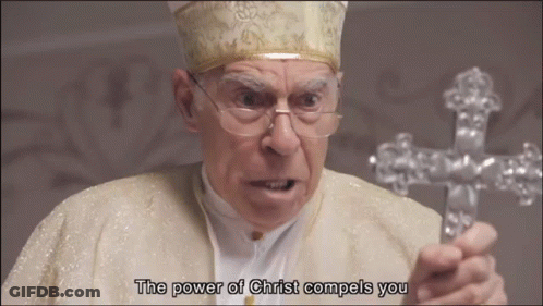 A Man Holding A Cross With The Words " The Power Of Christ Compels You " Below Him GIF