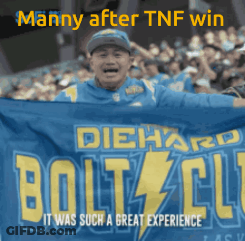 A Man Holding A Diehard Bolts Club Banner In Front Of A Crowd GIF