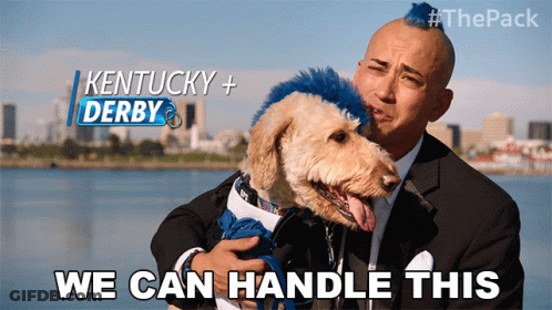A Man Holding A Dog With Kentucky + Derby Written On The Top GIF