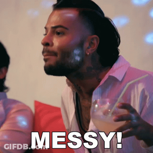 A Man Holding A Drink With The Word Messy Written On The Bottom GIF