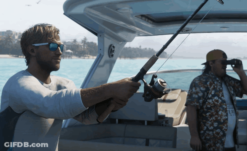 A Man Holding A Fishing Rod On A Boat While Another Man Looks Through Binoculars GIF