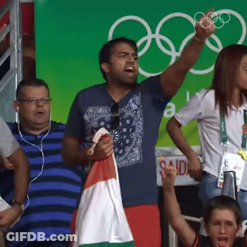 Man Holding Flag In Front Of Said Sign GIF
