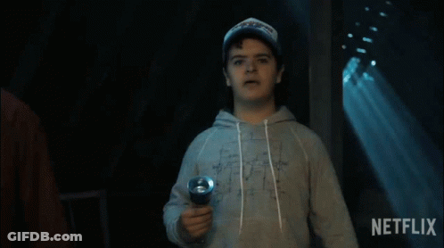 A Man Holding A Flashlight With A Netflix Logo In The Background GIF