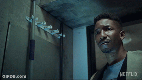 A Man Holding A Flashlight With A Netflix Logo In The Background GIF
