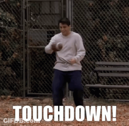 A Man Holding A Football In Front Of A Chain Link Fence With The Words Touchdown Written On The Bottom GIF