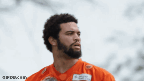 A Man Holding A Football With A Name Tag That Says Advocacy Health Care GIF