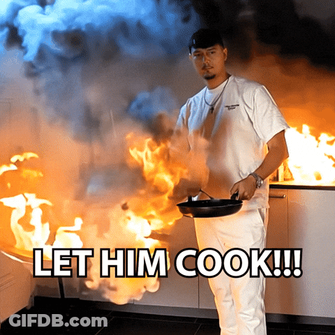 A Man Holding A Frying Pan In Front Of A Fire With The Words Let Him Cook Below Him GIF