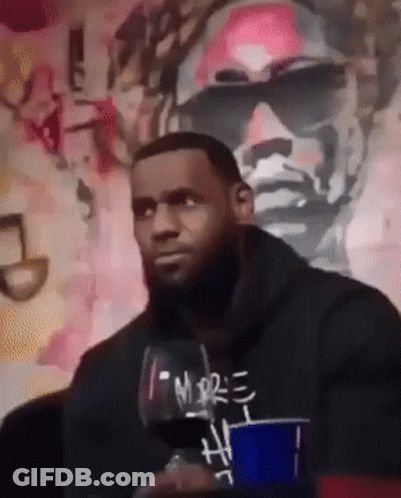 A Man Holding A Glass Of Wine With The Word More On It GIF