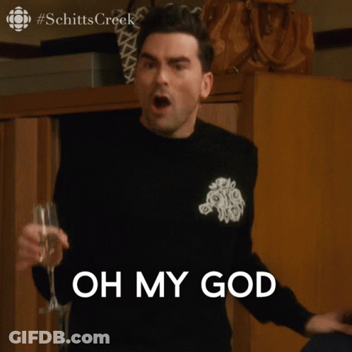 A Man Holding A Glass Of Wine With The Words Oh My God Behind Him GIF