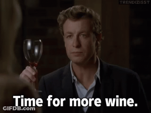 A Man Holding A Glass Of Wine With The Words Time For More Wine Below Him GIF