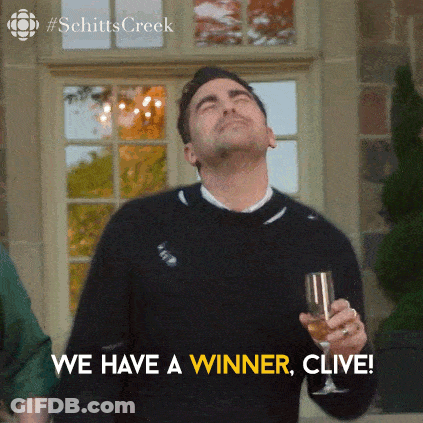 A Man Holding A Glass Of Wine With The Words We Have A Winner Clive Below Him GIF
