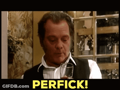 A Man Holding A Glass With The Word Perfick On The Bottom GIF