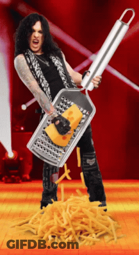 A Man Holding A Grater With A Piece Of Cheese In It GIF