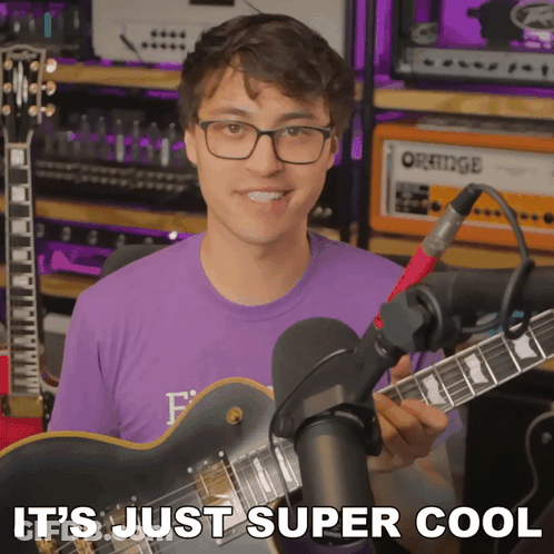 Man Holding Guitar With Super Cool Above GIF