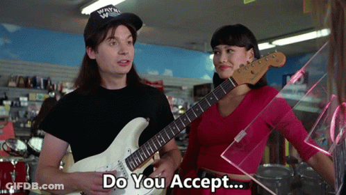 A Man Holding A Guitar Next To A Woman With The Words Do You Accept GIF