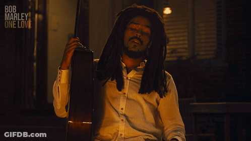 A Man Holding A Guitar With The Words All My Life Below Him GIF
