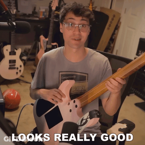 Man Holding Guitar Looks Really Good GIF