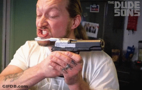 A Man Holding A Gun And A Toothbrush With The Dude Song Written On The Bottom GIF