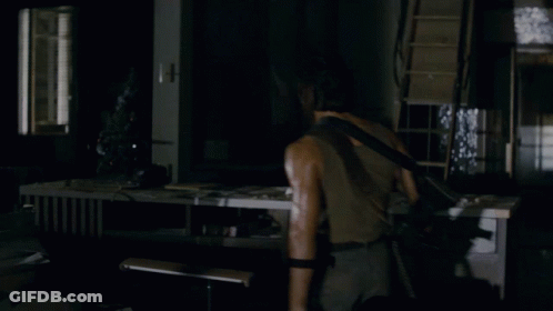 A Man Holding A Gun In A Dark Room With The Words Nothing Is Over Below Him GIF