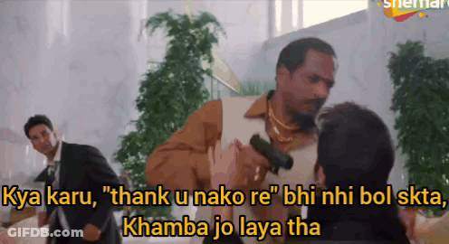 A Man Holding A Gun Says " Thank U Nako Re " While Another Man Watches GIF