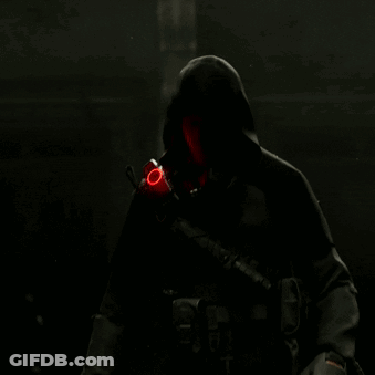 A Man Holding A Gun With A Red Circle On His Wrist GIF
