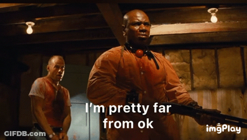 A Man Holding A Gun With The Words I 'M Pretty Far From Ok Below Him GIF