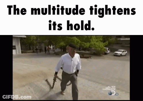 A Man Holding A Gun With The Words The Multitude Tightens Its Hold Above Him GIF