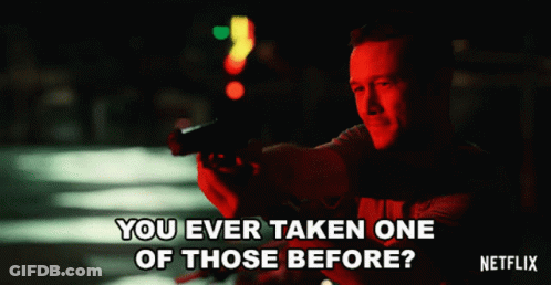 A Man Holding A Gun With The Words " You Ever Taken One Of Those Before " On The Bottom GIF