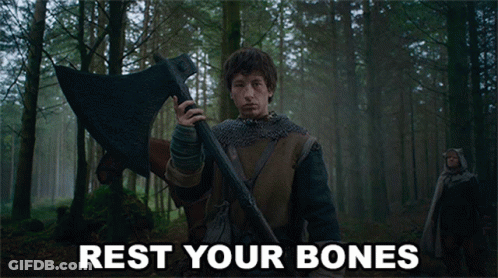 A Man Holding A Large Axe In A Forest With Rest Your Bones Written On The Bottom GIF