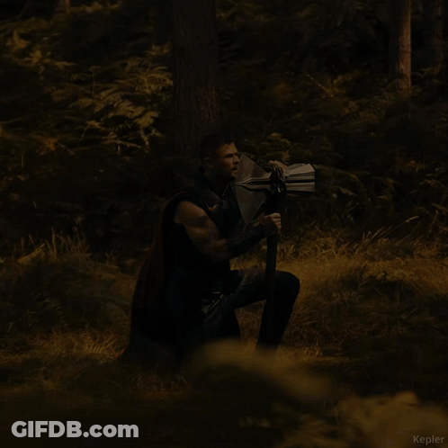 A Man Holding A Large Axe In A Forest With The Name Kepler Visible In The Corner GIF