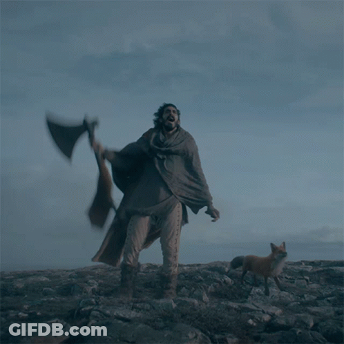 Man With Axe And Fox Nearby On Rocky Hill GIF