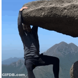 A Man Holding A Large Rock Over His Head GIF