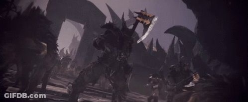 A Man Holding A Large Sword In A Dark Room GIF