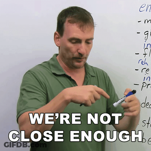 A Man Holding A Marker In Front Of A White Board With The Words We 'Re Not Close Enough GIF