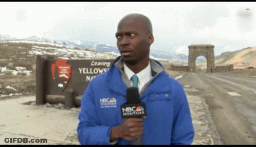 A Man Holding A Microphone In Front Of A Sign That Says " Leaving Yellowstone " GIF