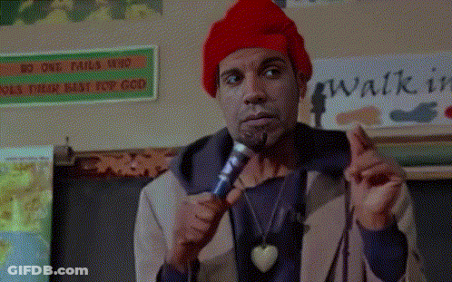 A Man Holding A Microphone In Front Of A Sign That Says " Walk In " GIF