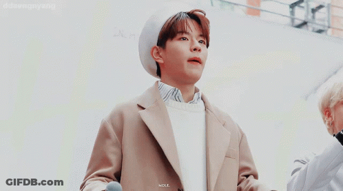 A Man Holding A Microphone Next To Another Man With The Word Daesongyang On The Bottom Left GIF