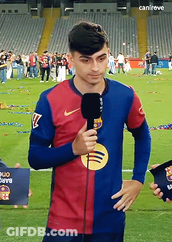 A Man Holding A Microphone On A Soccer Field With The Word Canireve On The Bottom Right GIF