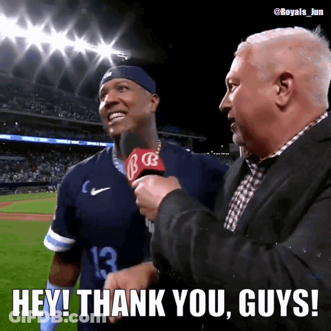 A Man Holding A Microphone Says " Hey Thank You Guys " In Front Of A Baseball Player GIF