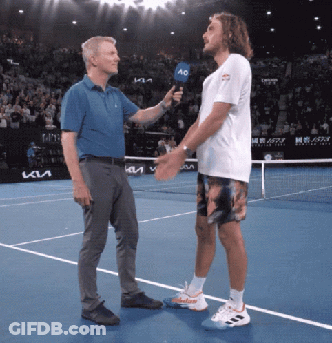 A Man Holding A Microphone Talks To A Tennis Player On The Court GIF