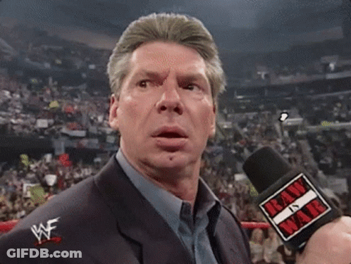 A Man Holding A Microphone That Says Raw In War On It GIF
