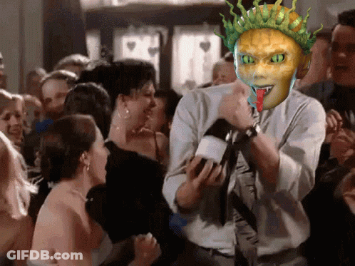 A Man Holding A Microphone With A Mask On His Face GIF