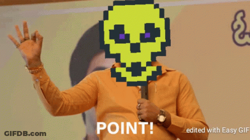 A Man Holding A Microphone With A Pixelated Skull On His Face And Point Written Below Him GIF